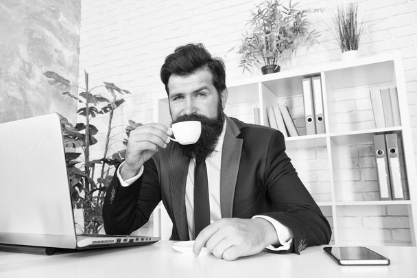 First thing in the morning. Bearded man drink morning coffee in office. Manager enjoy hot drink in morning. Breakfast tea. Ultimate morning routine - Фото, изображение
