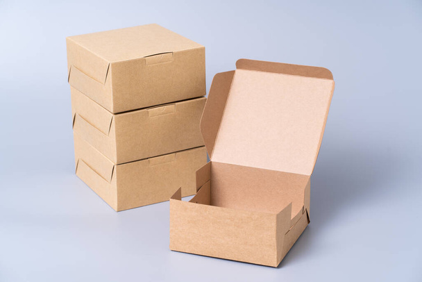 Brown paper box for food package. carton on a gray background. - 写真・画像