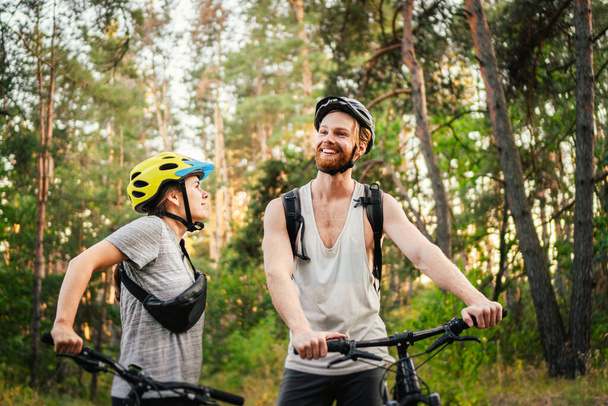 自転車利用者。カップルサイクルMTBトレイルトラック。アウトドアスポーツ活動。森の中のバイクとカップル.一緒に田舎のサイクルに乗る。自転車でのロマンチックな旅。週末だ。スポーツカップル. - 写真・画像