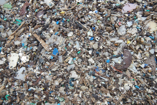 Micro plastics marine debris on the sand beach.                                - Photo, Image
