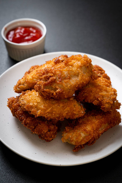 fried chicken wings with ketchup - unhealthy food - Fotó, kép