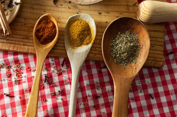 A shot of spices in wooden spoons - 写真・画像