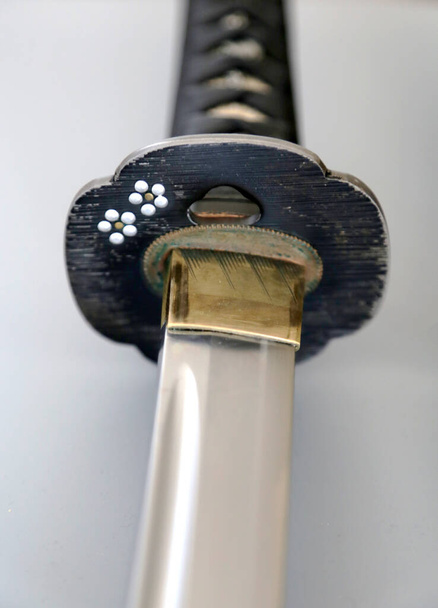 A closeup shot of the details of a traditional Japenese katana sword handle - Zdjęcie, obraz