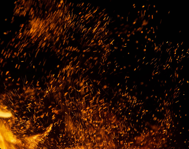 fire flames with sparks on a black background - Foto, imagen