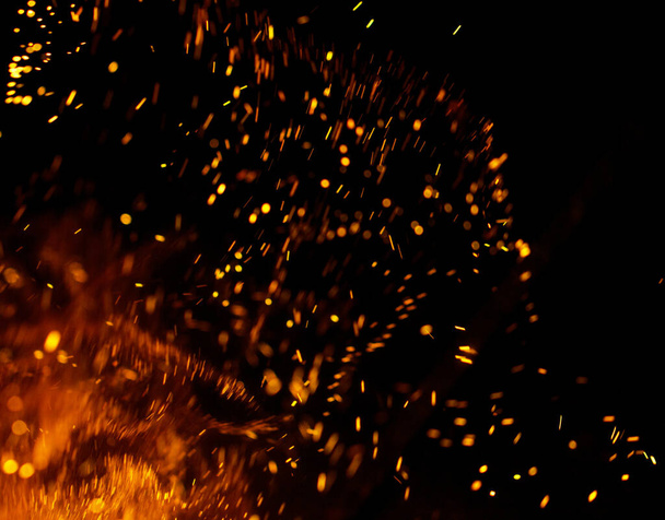 Flame of fire with sparks on a black background - Photo, Image