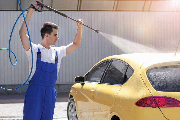 Worker of car wash cleaning modern automobile - Фото, зображення