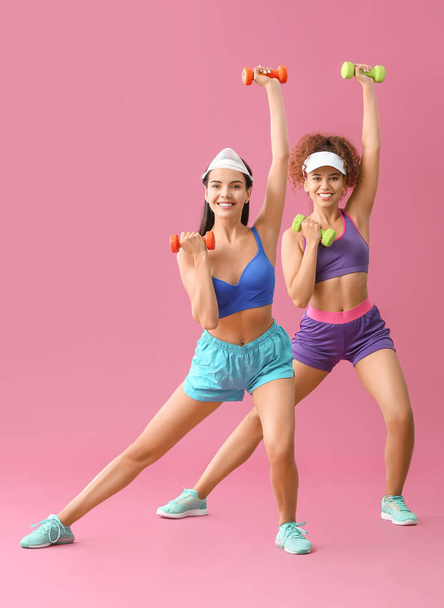 Young women doing aerobics on color background - 写真・画像