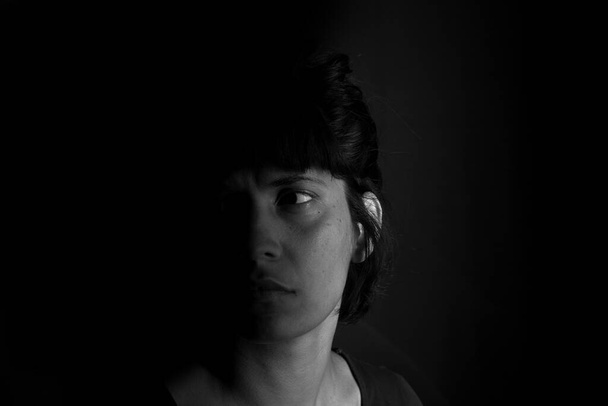Dramatic portrait of an indian girl on black background - Photo, Image