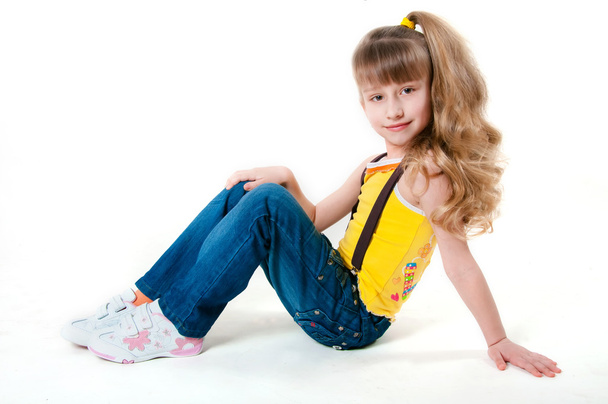 Little girl in jeans on a white background - Zdjęcie, obraz