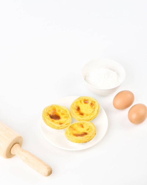 Egg tarts, eggs and other ingredients and tools on white  background - Photo, Image