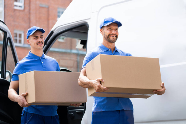 Truck Movers Loading Van Carrying Boxes And Moving House - Photo, Image