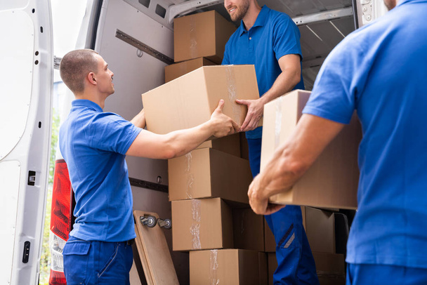 Truck Movers Loading Van Carrying Boxes And Moving House - Foto, Imagen