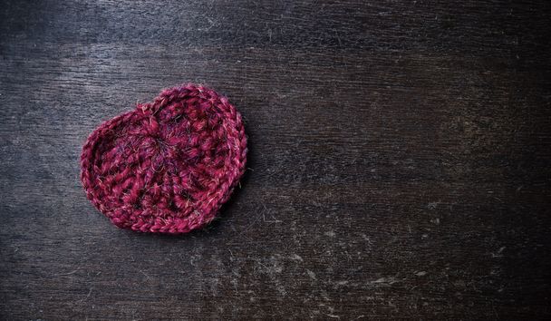 Knitted red heart on a wood background - Zdjęcie, obraz