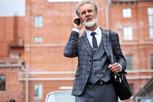 gray bearded businessman hurrying to business meeting - Zdjęcie, obraz
