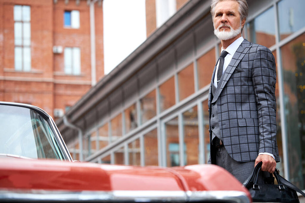 old rich fashionable man next to the luxury automobile - 写真・画像