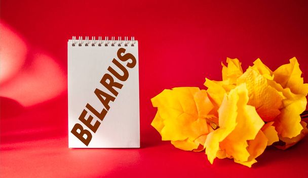 Calendar with the inscription Belarus on a red background and a maple branch - Photo, Image