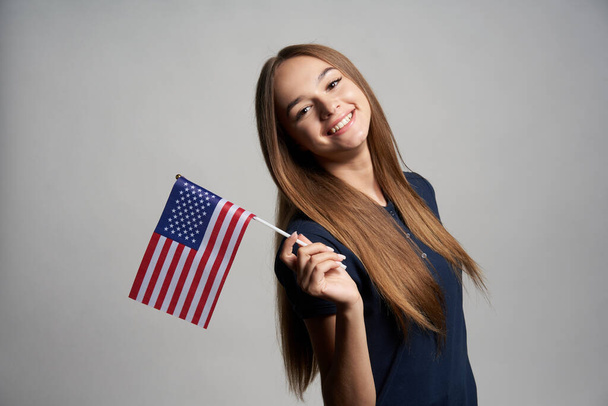 Happy female holding USA flag - Фото, зображення