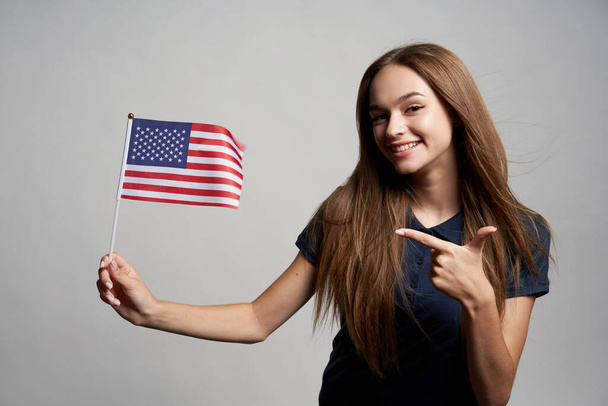 Happy female holding USA flag - Foto, afbeelding