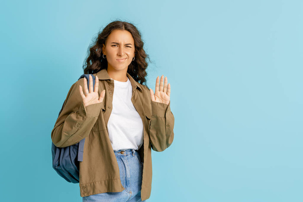 Emotional young woman in casual clothes saying "not" on bright blue background - Foto, afbeelding