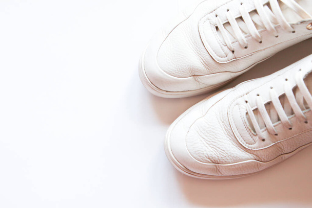 White leather sneakers on white background - Foto, afbeelding