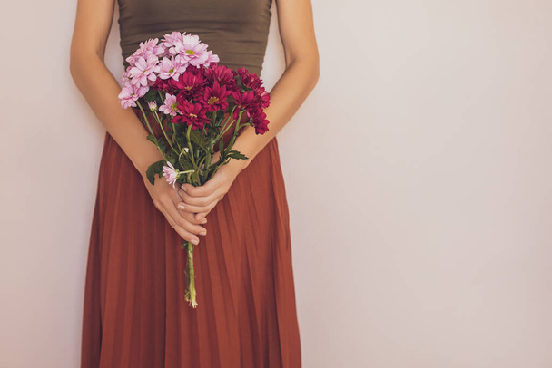 Woman holding beautiful bouquet of flowers.Focus on flowers. - 写真・画像