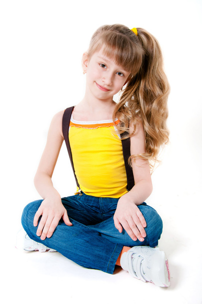 Little girl in jeans on a white background - Фото, зображення