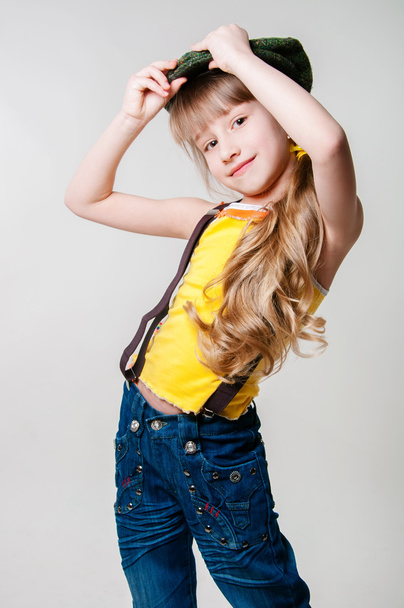 Little girl in jeans on a white background - Foto, Bild