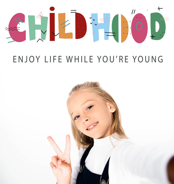 schoolgirl showing victory sign while taking selfie on white background, childhood illustration - Photo, image
