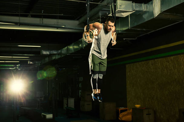 Muscle ups rings man swinging workout exercise at gym - Фото, зображення