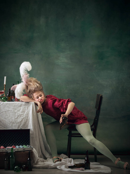 Young woman as Marie Antoinette on dark background. Retro style, comparison of eras concept. - Foto, Imagem