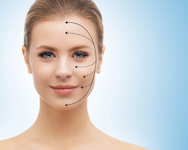 Young, beautiful and healthy woman with arrows on her face. Spa, surgery, face lifting and make-up concept - Photo, image