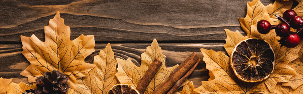 top view of autumnal decoration and foliage on brown wooden background, panoramic shot - Photo, Image