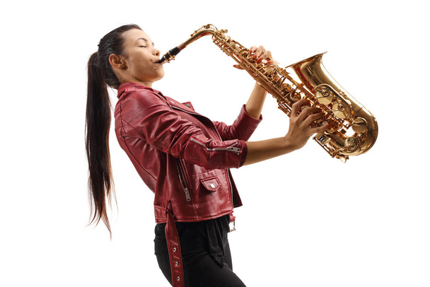 Female saxophonist in a red leather jacket playing a sax isolated on white background - Φωτογραφία, εικόνα
