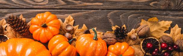 top view of autumnal decoration and pumpkins on brown wooden background, panoramic shot - Photo, Image