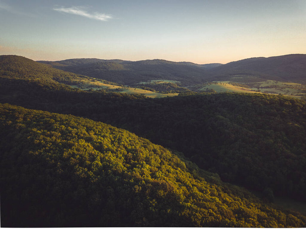 A closeup shot of forests and hills - Fotó, kép