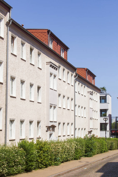 A low angle shot of a building on a blue sky background in Mecklenburg-Vorpommern, Germany - Zdjęcie, obraz