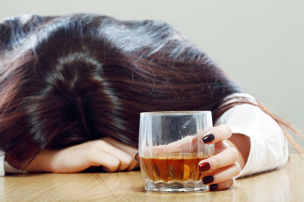 Woman holding drink and sleeping - Zdjęcie, obraz