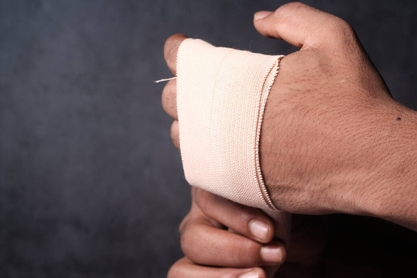 person hands with gauze bandage wrapped around . - Photo, Image