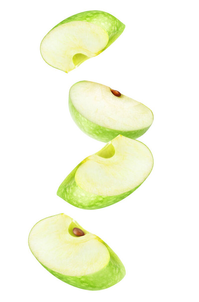 Isolated apple wedges in the air. Four falling pieces of green apple fruit isolated on white background - Photo, Image