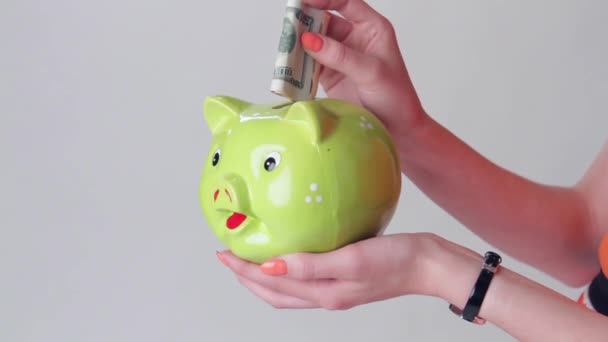 girls hand holding money box money goes into piggy bank - Footage, Video
