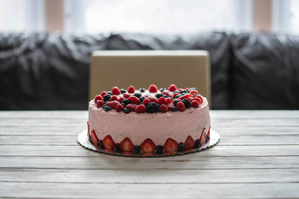 Home made cake with berries. Cake with Strawberry, blackberry, blueberry, and raspberry on a table - Photo, Image