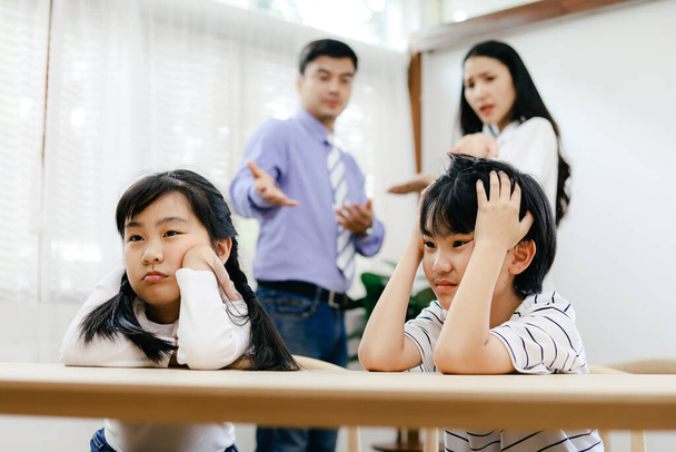 Family problems concept, father and mother quarreling in the house so causing children to feel bad. - 写真・画像