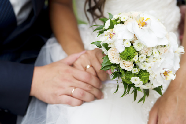 Bouquet and hands with rings - Photo, Image