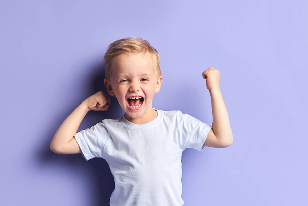 Joyful kid boy show emotions at camera - Photo, image