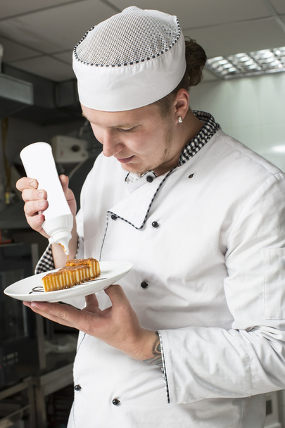 Chef preparing food in the kitchen - Фото, изображение