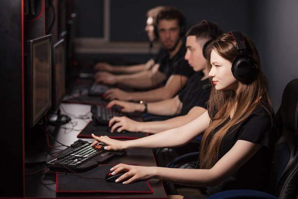 Woman in team of eSport Gamers Playing Video Games on a cyber games contest. - Fotografie, Obrázek