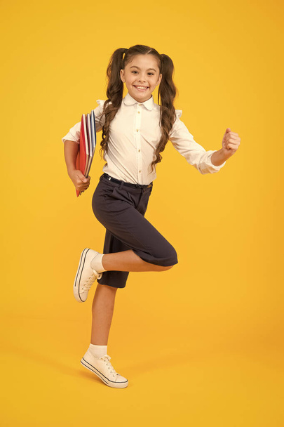 Hurry up. Keep going. Active kid. Girl with books on way to school. Knowledge day. Back to school. Kid cheerful schoolgirl running. Pupil want study. Active child in motion. Beginning school lesson - Foto, Imagem