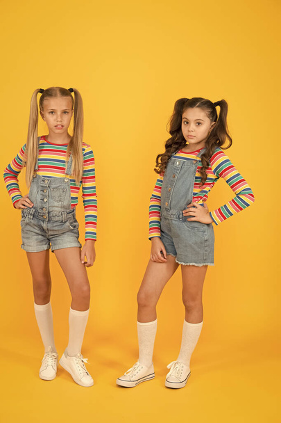 Trendy and fancy. Fashion shop. Must have accessory. Vibrant colors. Modern fashion. Kids fashion. Girls long hair. Cute children same outfits. Little girls wearing rainbow clothes. Matching outfits - Fotoğraf, Görsel
