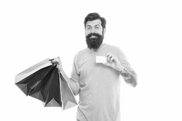 Personal discount. Buy online. Pay online. Credit card. Bearded man with bags and discount card. Purchase concept. Happy man shopping. Payment method. Bank card. Black friday sale. Satisfied customer - Foto, afbeelding