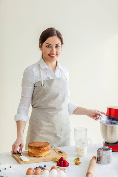 happy gorgeous chef in apron cooking tasty cake for family - Zdjęcie, obraz